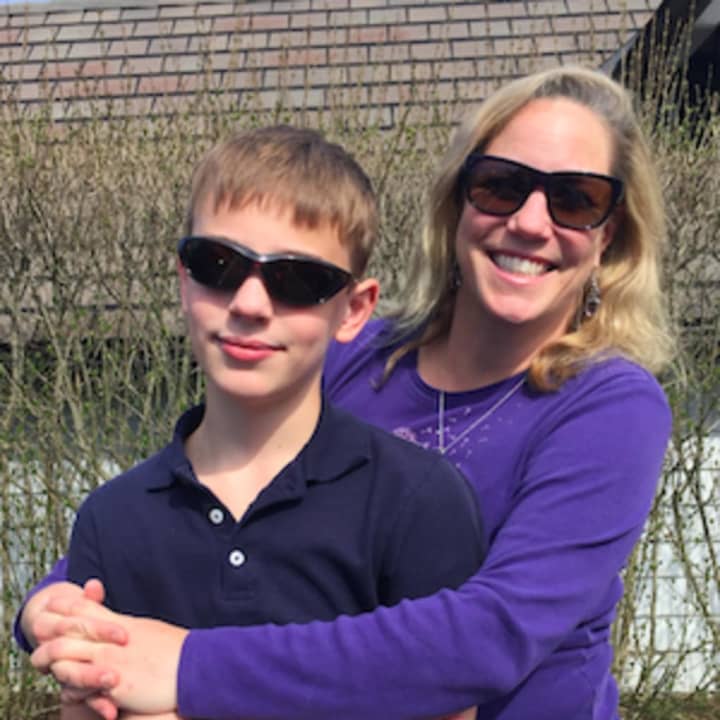 Kenny Backes with his mother Megan. The Stamford boy suffers from a genetic eye disease, and his family is having a tag sale April 23 to raise money for research.
