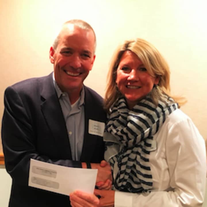Jim Bosek, Shelter for the Homeless board chair, with New Canaan Community Foundation board member Kay Linneman after receiving a $12,500 grant to support the shelter’s emergency meals program.