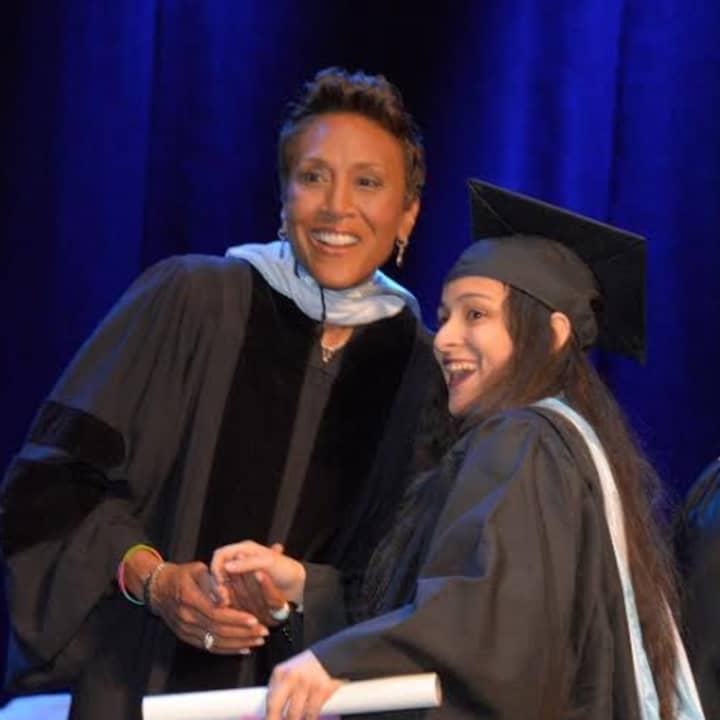 The College of New Rochelle commencement speaker Robin Roberts, left, shakes hands with new graduate Bianca Jeannot, a Bronx resident.