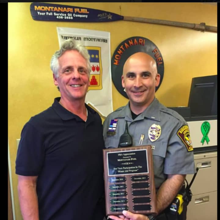 From left, Andy Montanari Jr. and Ridgefield Lt. Jeff Raines. The Ridgefield Police Benevolent Association presented Montanari Fuel with a plaque of appreciation for assisting with the “Winter Aid” program since its start.