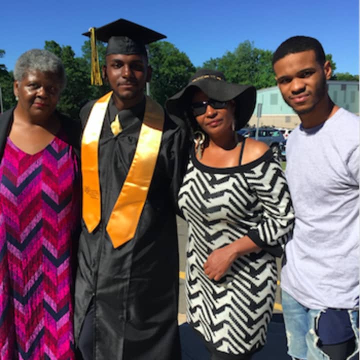 Louis Ray, of Bridgeport, surrounded by family as he prepares for AITE&#x27;s graduation on Tuesday. From left are his grandmother Roxie Ray, Stratford; his mother Karene Thames and his brother Chris Deveaux. Louis Ray will be joining the Navy in December