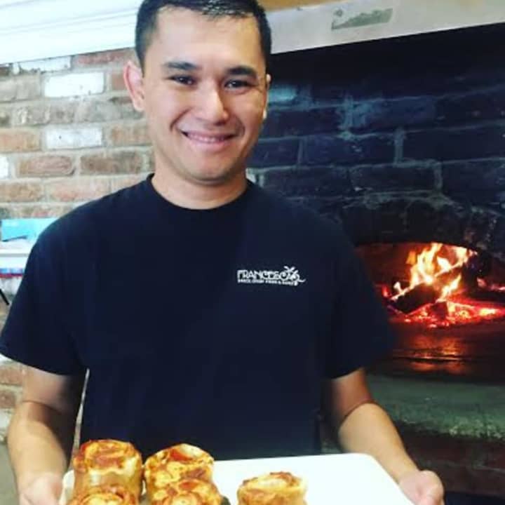 Salvatore Reina holds pizza rolls in Francesca Pizza.