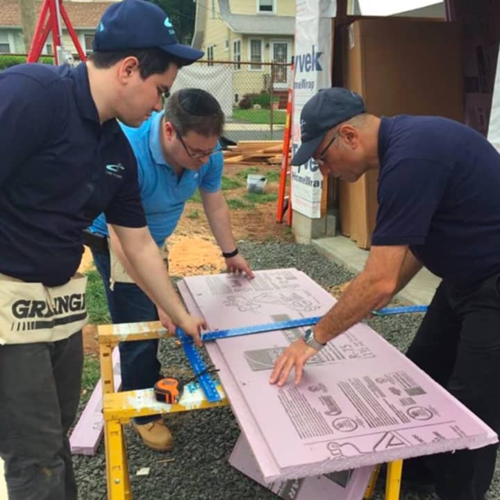 Cross River Bank employees draw up plans on Habitat Bergen&#x27;s Bergenfield site.