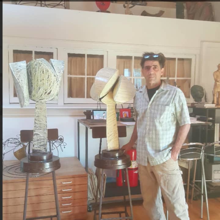 Boyajian poses with some of his sculptures.