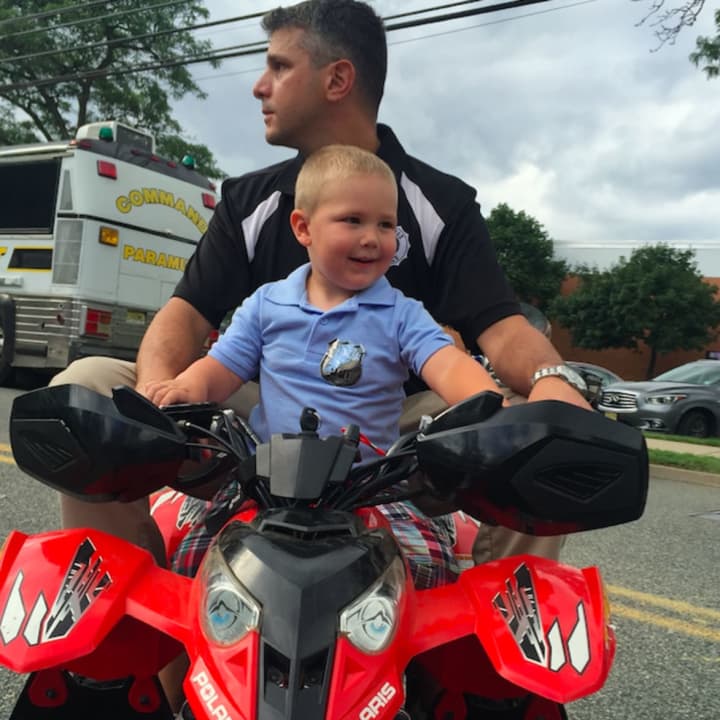 Tyler, 3, gets a ride from Paramus Police Officer Brian Linden with the department&#x27;s motorcycle unit.