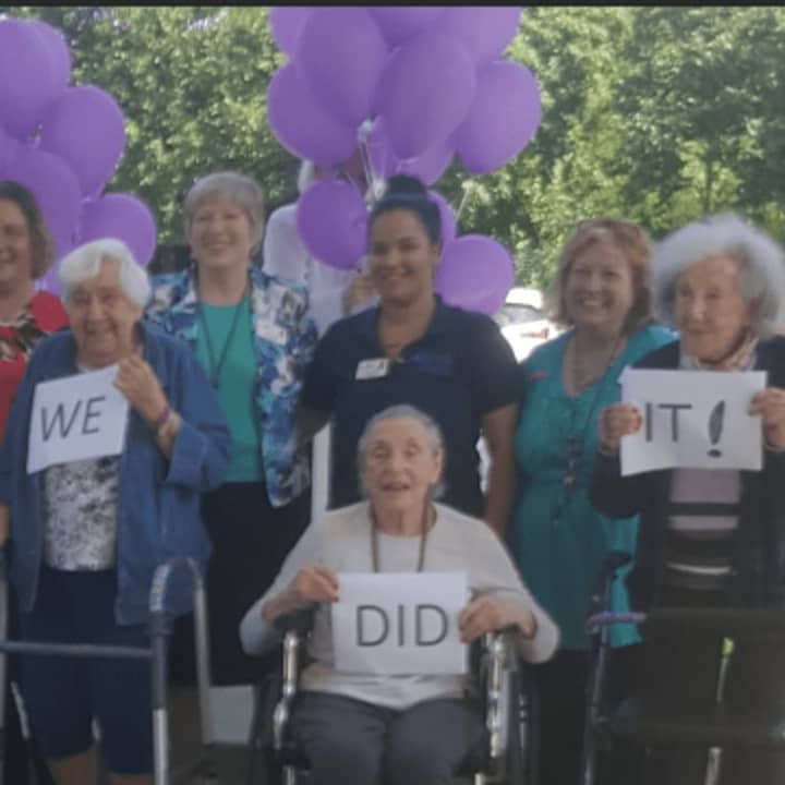 Residents at Benchmark Senior Living at Ridgefield Crossings celebrate breaking the world&#x27;s record for creating the longest friendship bracelet.