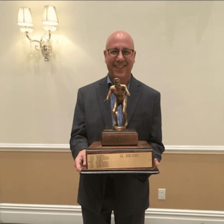Bergen Catholic wrestling coach Dave Bell holding the Group III, IV &amp; V County Championship trophy.