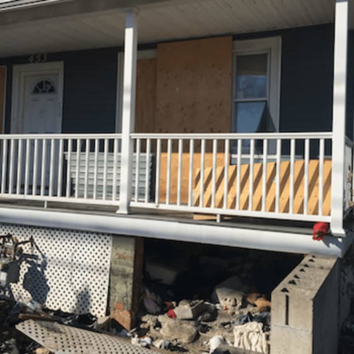 A mattress can just be barely seen under a porch of an abandoned home where a Guatemalan man was found dead Wednesday morning in Stamford. Police say there were no signs of foul play or trauma and believed death due to a medical issue.