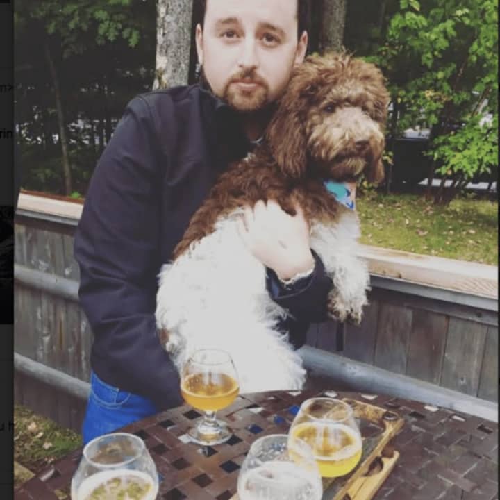 New Fairfield resident Erik Ofgang and his labradoodle Iris. Ofgang is the author of &quot;Buzzed: Beers, Booze &amp; Coffee Brews.&quot;