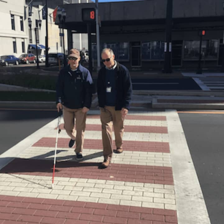 Phil Magalnick, left, a Stamford resident who is legally blind, and state official John Waiculonis walk across the new Z-shaped crosswalk on Washington Boulevard near the Government Center.