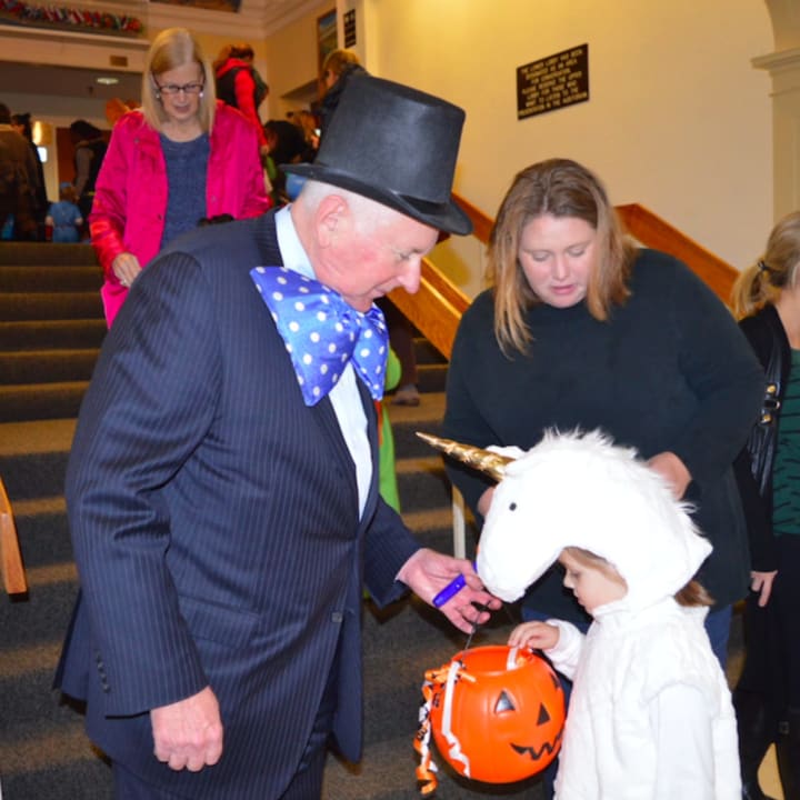 Westport First Selectman Jim Marpe, dressed in a mayor&#x27;s costume, greets kids and gives out candy at the 20th annual Halloween event, which was held this year at Westport Town Hall.