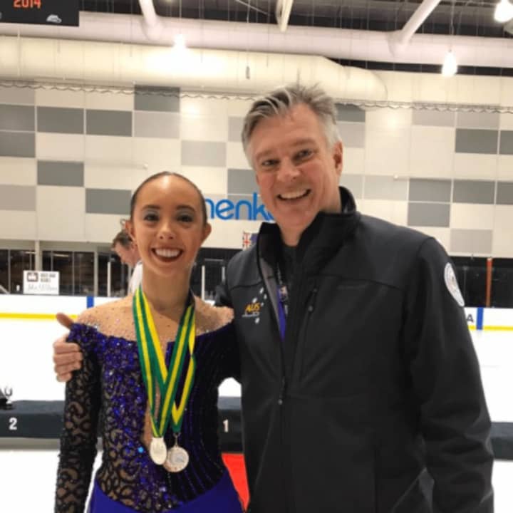 Brooklee Han, left, stands with her coach, Peter Cain, after winning a silver medal at the Australia Figure Skating Championships.