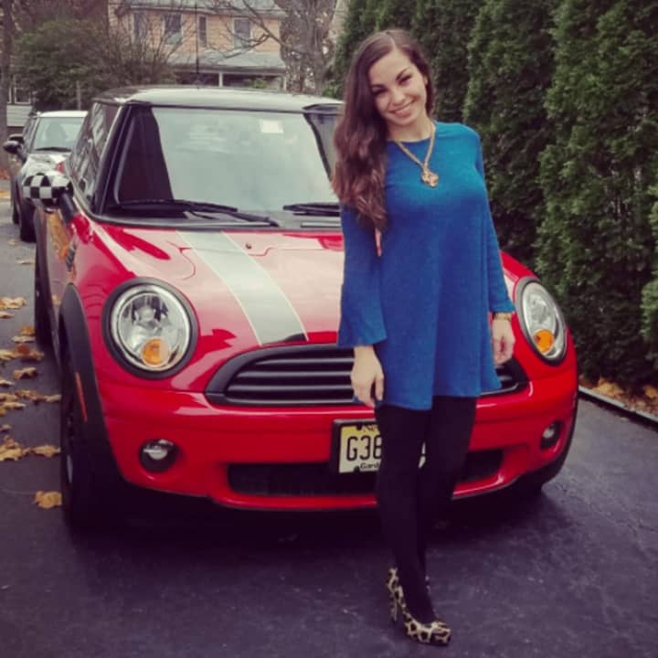 Brittany Tierney of Teaneck and her Mini Cooper. Mini Cooper owners will deliver toys from Prestige Mini in Ramsey to kids at the Audrey Hepburn Children&#x27;s House in Hackensack.