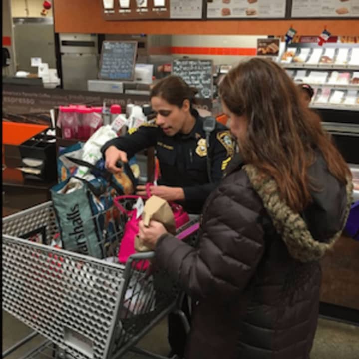 Sgt. Sofia Gulino checks with a customer on how to protect valuables from theft while shopping.