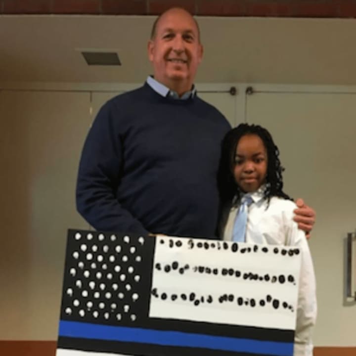 Stamford Police Chief Jon Fontneau presented a flag during Newfield School&#x27;s Police Appreciation Day.