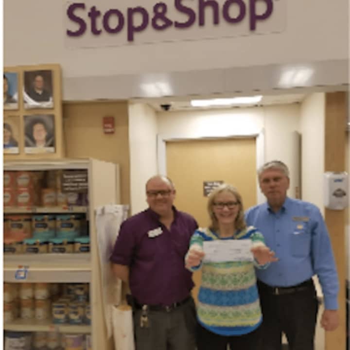 John Radaskie, front end manager for Stop &amp; Shop, left, and  store manager Richard Marcucio donate the check to Rev. Phyllis J. Leopold, ARC Executive Director.