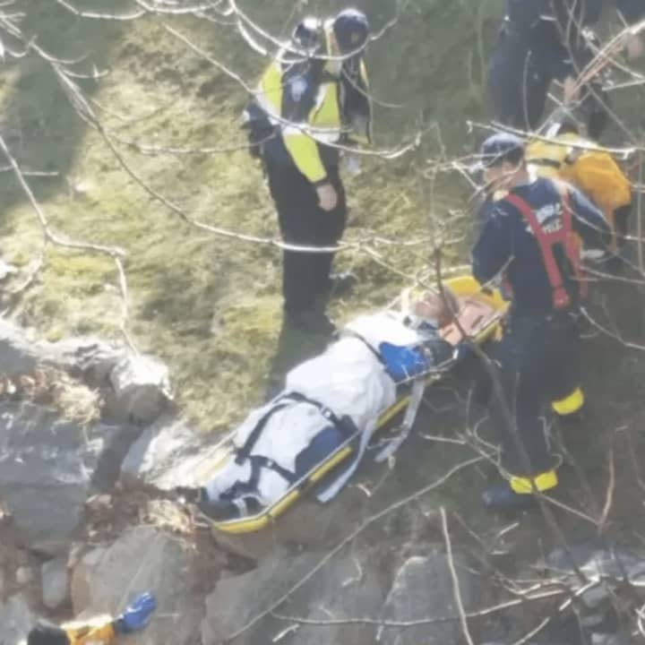 Norwalk first responders rescue a man who fell down an embankment and into the Norwalk River on Monday afternoon while walking his dog.
