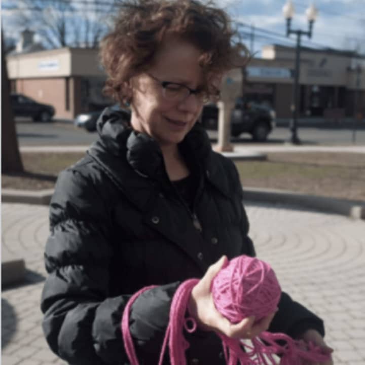 Bethel resident Laura Collins teaching a class on how to make pink pussy hats in the Bethel Municipal Center courtyard.