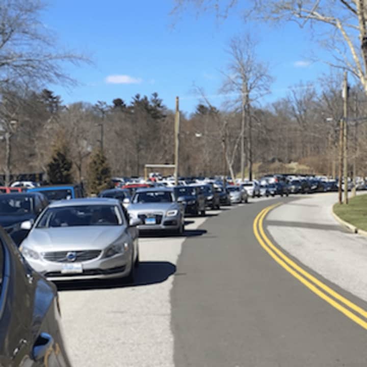 Motorists double parked outside Greenwich High School as they wait for a lockdown to end. Police said they are investigating a noontime threat at the school.