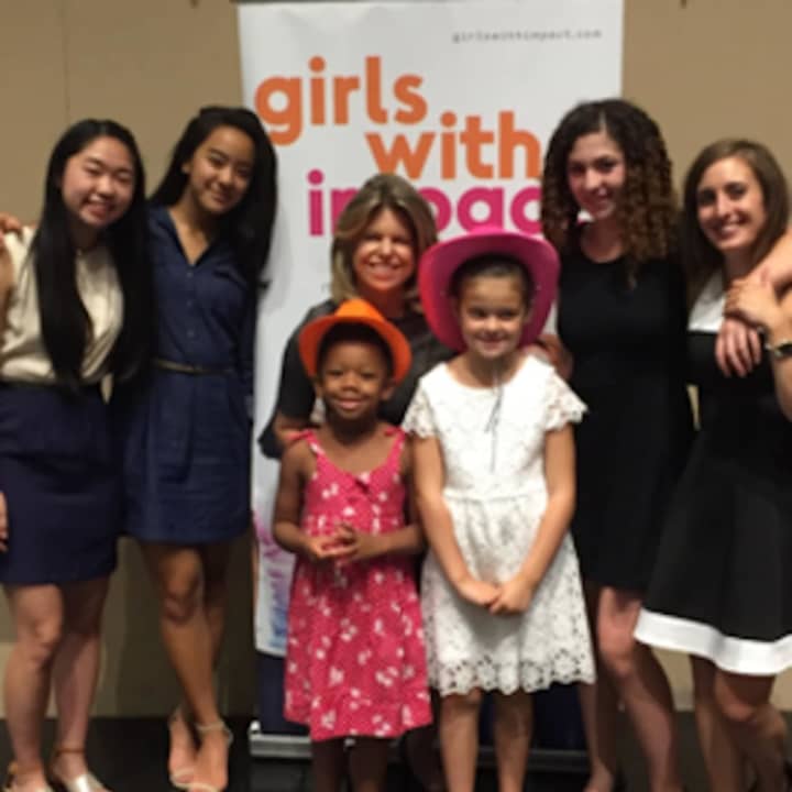 Girls with Impact members joined by CEO Jennifer Openshaw (center) and Head of Programming Dr. Natalie Miccile (far right), along with Openshaw’s two young daughters, Elizabeth and Gianna, celebrate after sharing their business ventures.
