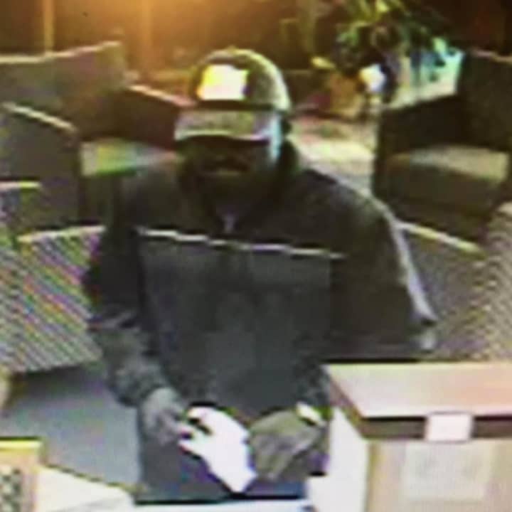 The suspect in the Friday robbery of the Newtown Savings Bank on Main Street/Route 25 was described as a black male in all dark clothing and a baseball hat.