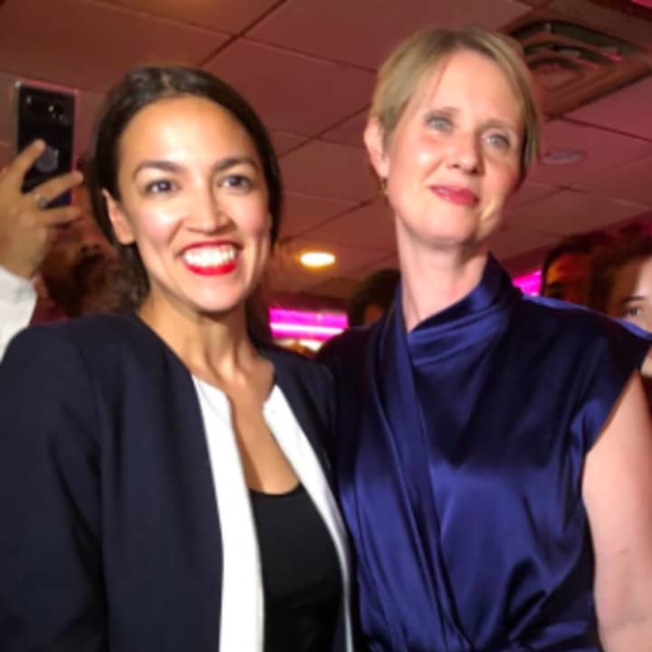 Gubernatorial long-shot Cynthia Nixon, right, celebrates Tuesday night&#x27;s Congressional win by Alexandria ­Ocasio-Cortez, a 28-year-old political newcomer who toppled incumbent U.S. Rep. Joe Crowley of Queens in Tuesday&#x27;s Democratic primary election.