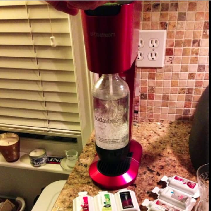 A SodaStream machine with flavor packets.
