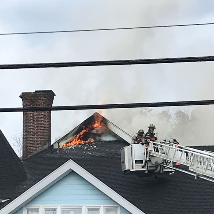 Flames can be seen shooting out of the roof of a 100-year-old tennis and swimming club.