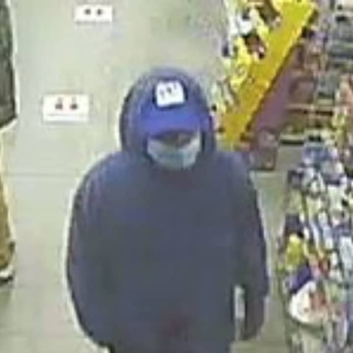 Suffolk County Police are attempting to locate a man who displayed a knife during a robbery at 7-Eleven in Islandia.