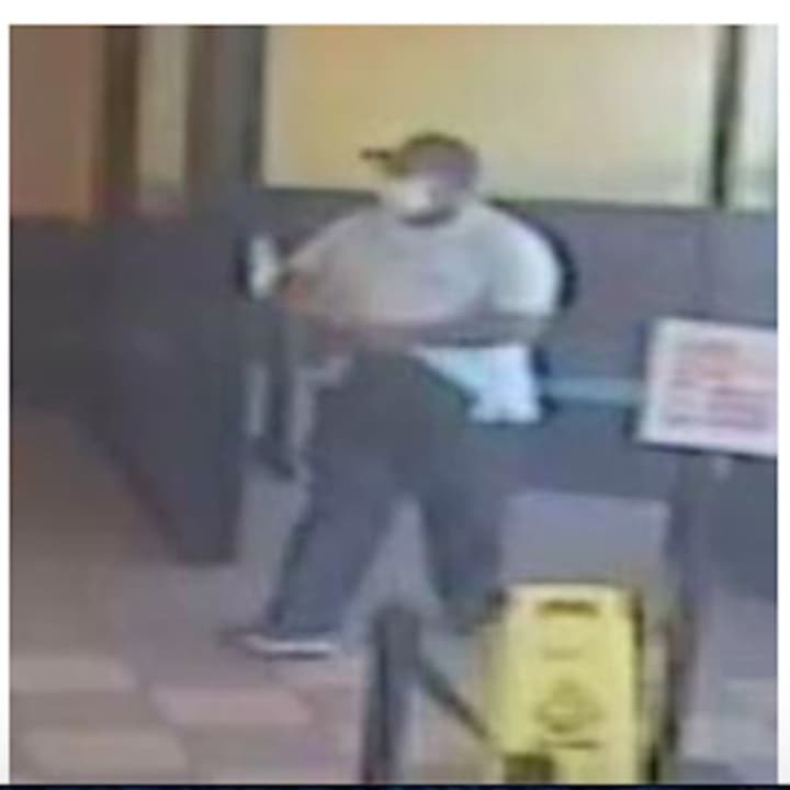 Police have released photos of a suspect who is at large after an armed robbery at a Long Island Dunkin’ Donuts.