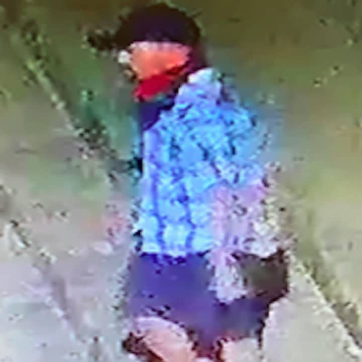A surveillance still of the wanted suspect