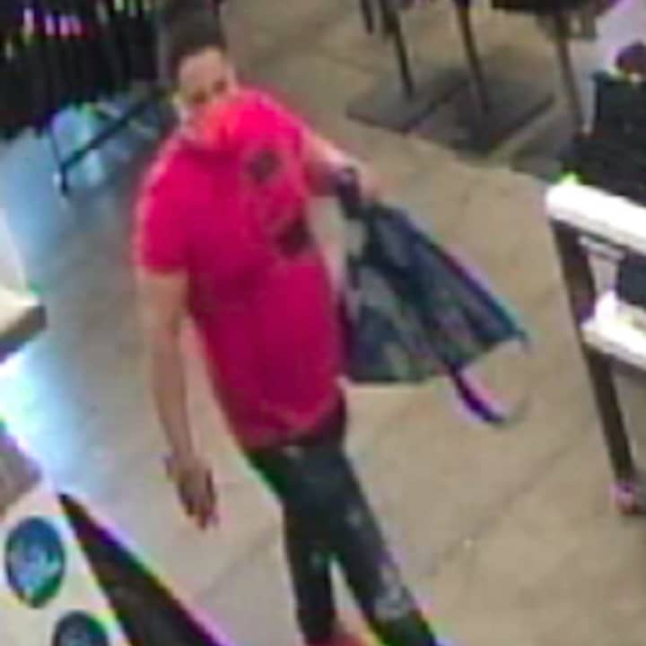 A still, captured from surveillance footage at Old Navy, of the wanted man.