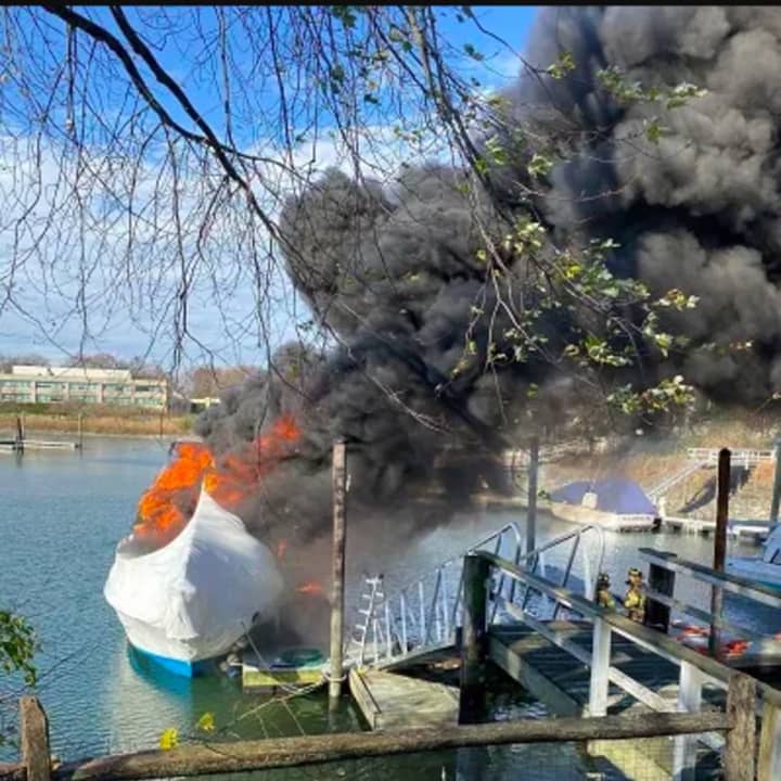 The 38-foot cabin cruiser located at a dock behind 109 Dolphin Cove Quay well-involved in flames.