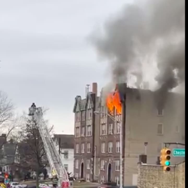 Flames shot out of the 4-story building at 118 West 2nd Street, as firefighters from surrounding areas arrived around 11:15 a.m.
