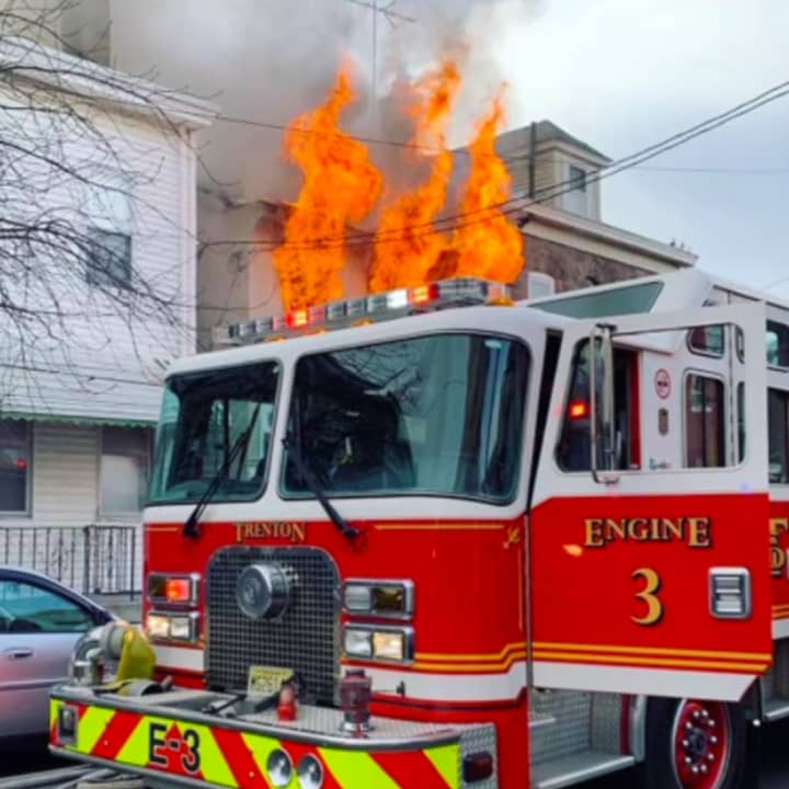 Trenton firefighters rescued one person from a three-alarm house fire on Friday.