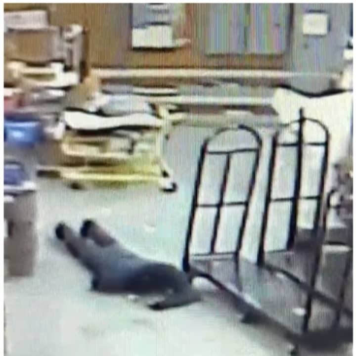 The burglar can be seen crawling along the floor to avoid security cameras.