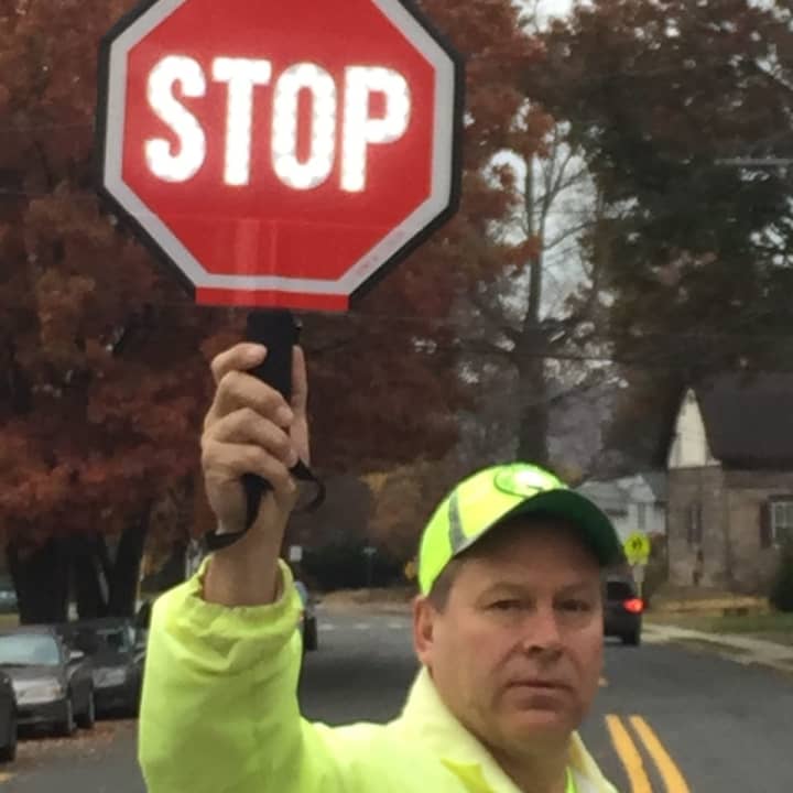 Northvale crossing guard Kurt Sidorak uses a new LED flashing stop sign.