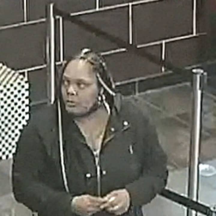 This woman is at large after punching a Long Island restaurant employee, police say.