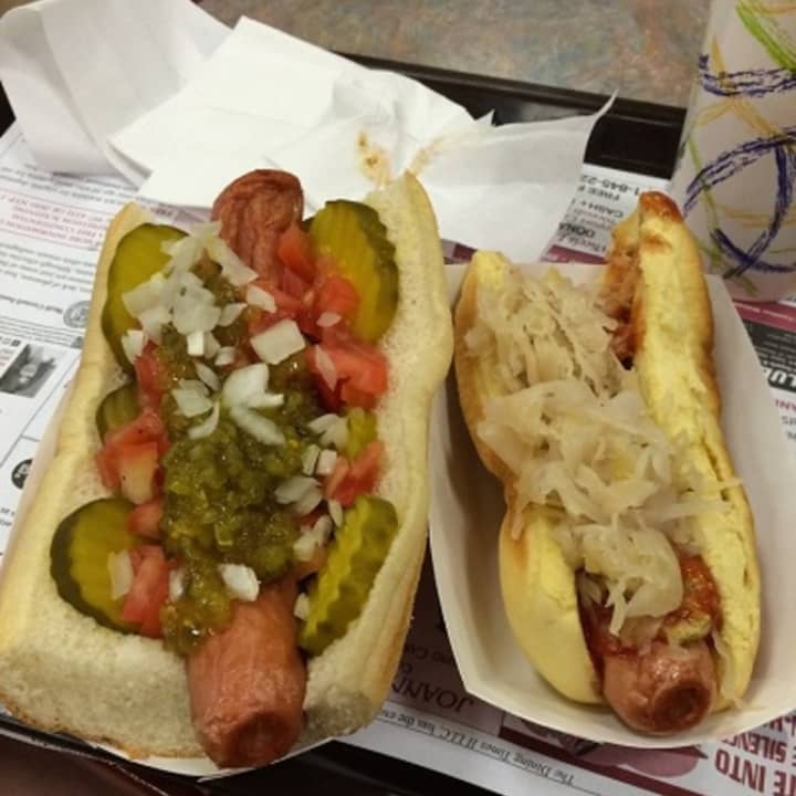 A Chicago Dog, left, with pickles, tomatoes, relish and onions, and the New York Dog, with sauerkraut and red onions at The Dog House in Nanuet.