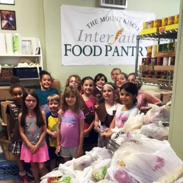 Folks from throughout the area support the Mount Kisco Interfaith Food Pantry -- even without fines. The Girl Scouts of Bedford Troop 1443 helped pack bags of produce this summer.
