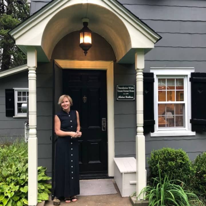 Trish Sullivan Rothberg in front of her home