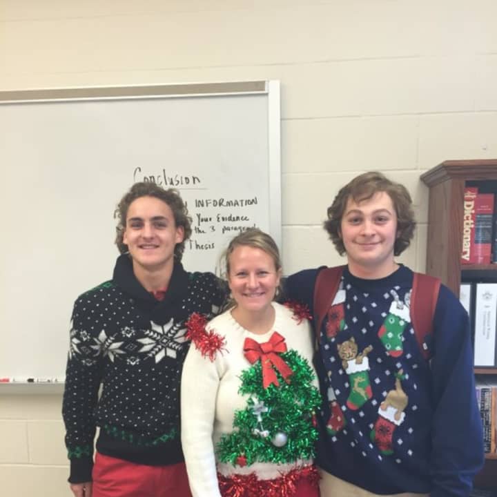 Trinity-Pawling School assistant athletic trainer Emily Tucci is flanked by hockey players Justin Lampert and Jordi Jefferson during their Ugly Sweater Day.