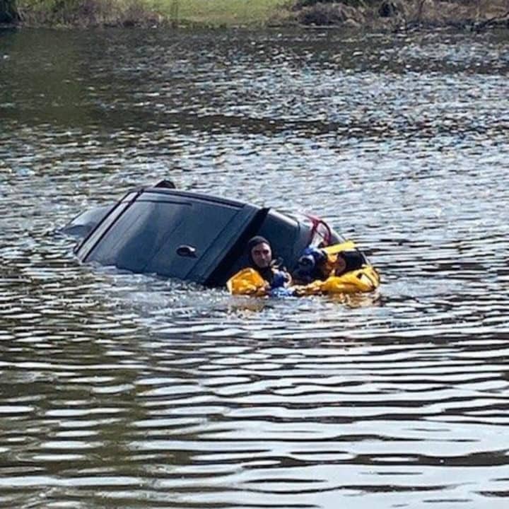A woman was rescued by police after she drove her vehicle into a lake.