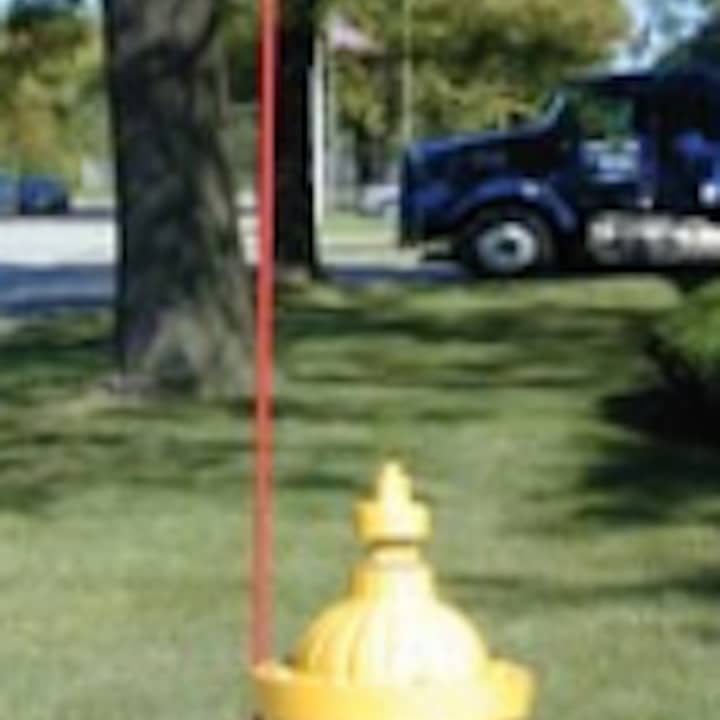 The red markers that will soon be affixed to fire hydrants in Scarsdale stand approximately three feet tall