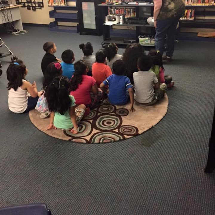 Children gather for a program at the Bridgeport Pubic Library. The library has acquired two sites that will allow for expanded programming.