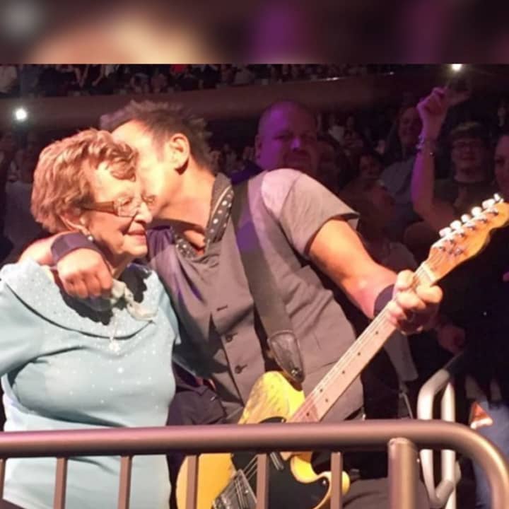 Rock legend Bruce Springsteen kissing his mother Adele during a performance.
  
