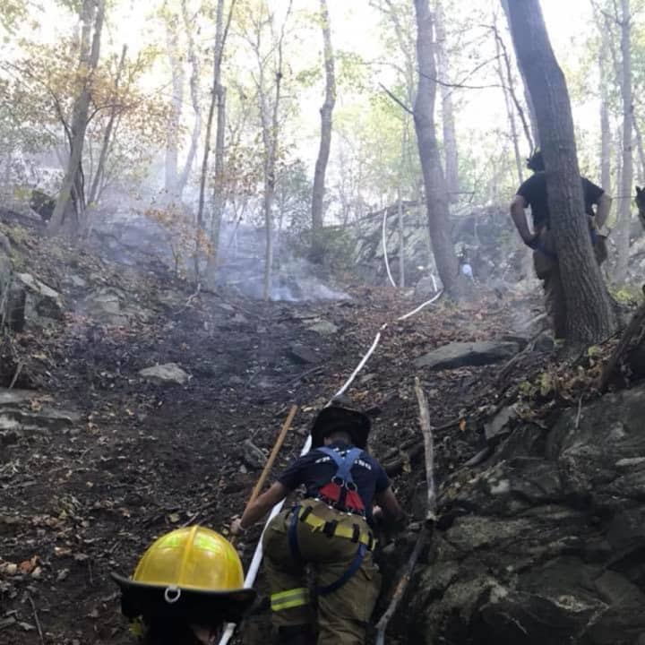 Crews are continuing to battle a large brush fire on the Terre Haute property in Bethel