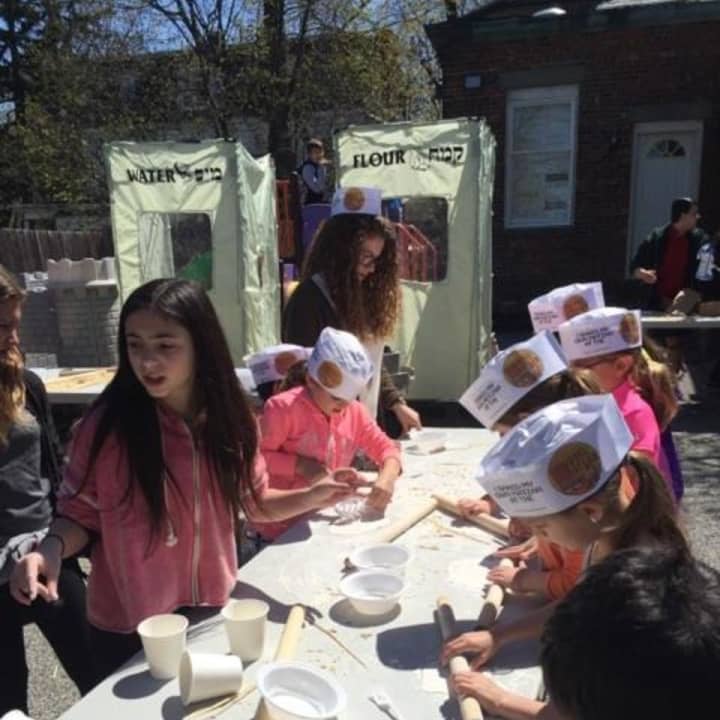 Youth at Chabad of the Rivertowns learned the 15 steps of the seder. Here, they learned to make Matza.