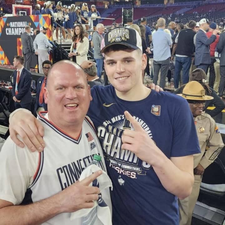 Eversource&nbsp;electric field operations supervisor&nbsp;Bill Clingan celebrates UConn's win with his son, center Donovan Clingan.&nbsp;