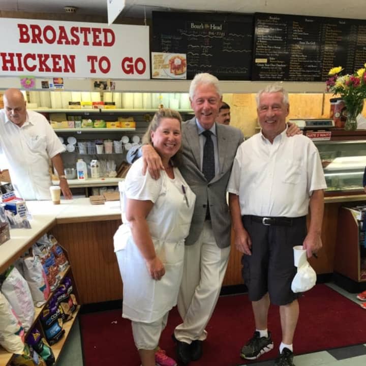 Former President Bill Clinton, a longtime Chappaqua resident, poses for a photo with Richard Lange (at right) and the staff at Lange's Little Store &amp; Delicatessen in Chappaqua in 2016.